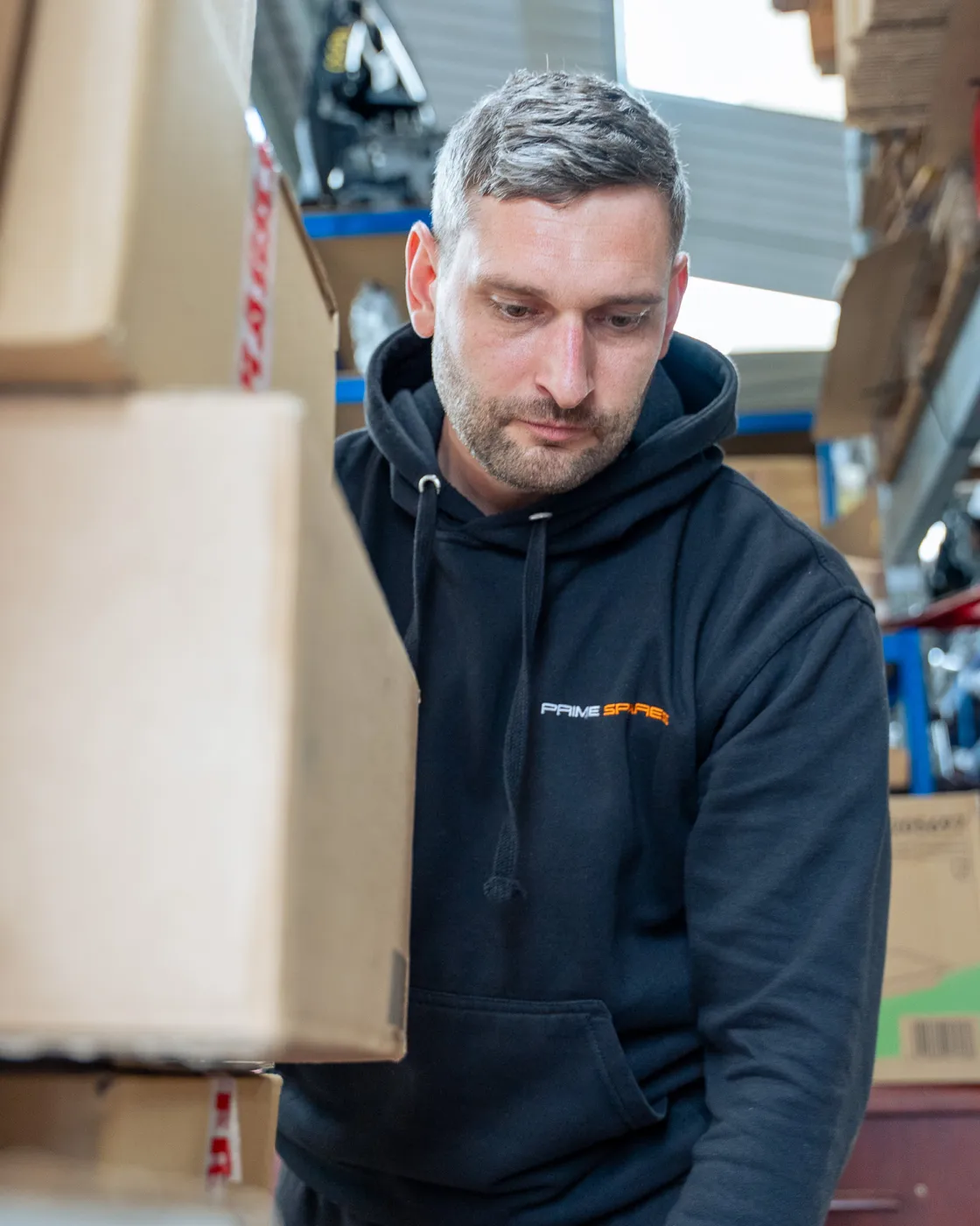 Prime Spares team member carrying a packed parcel