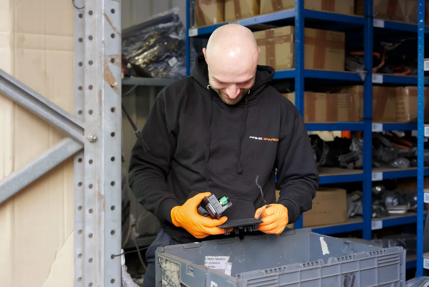 Prime Spares team member inspecting an automotive part