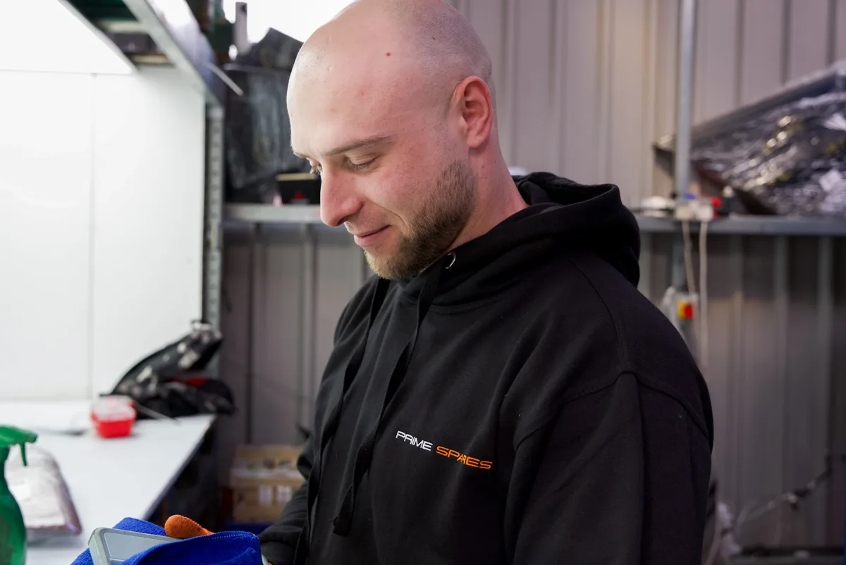 Prime Spares: A team member preparing a part at a workbench